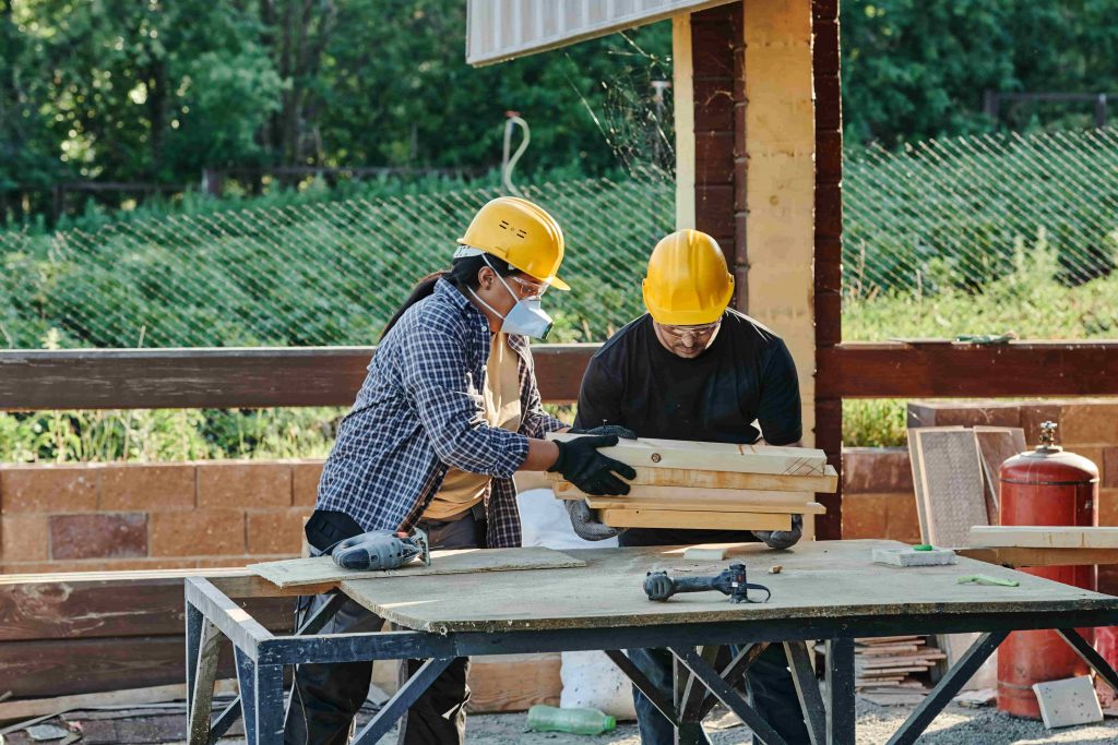 Construction workers implement various task on the site