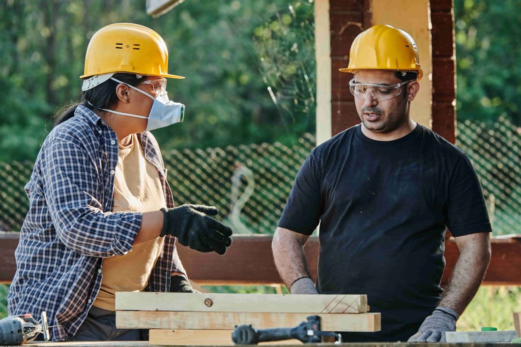 Trade foreman discussing construction process with carpenter